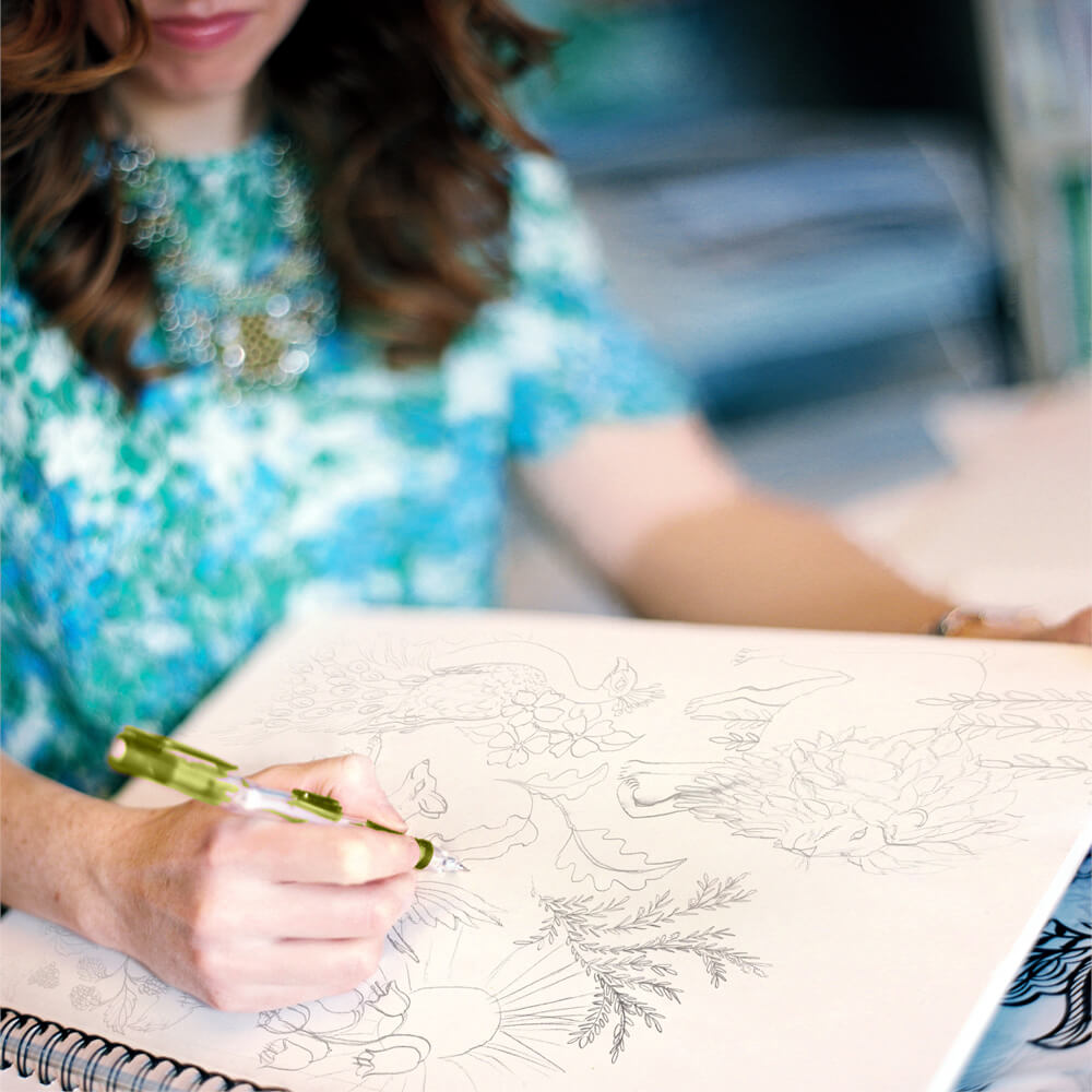 Josephine Kimberling the artist behind OOMF Creative drawing in her sketchbook is how all designs start for greeting cards and gift wrap